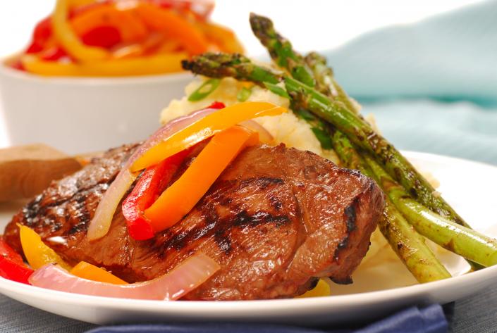 Beef entree prepared with fresh asparagus and bell peppers.