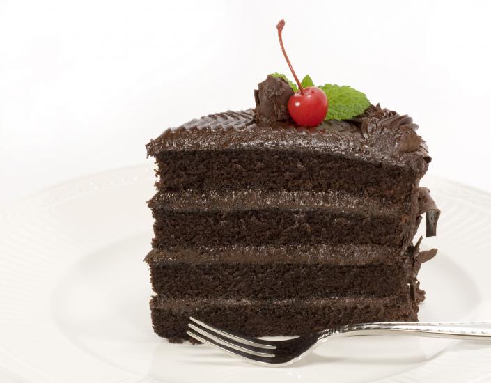 Layered chocolate cake with a cherry on top