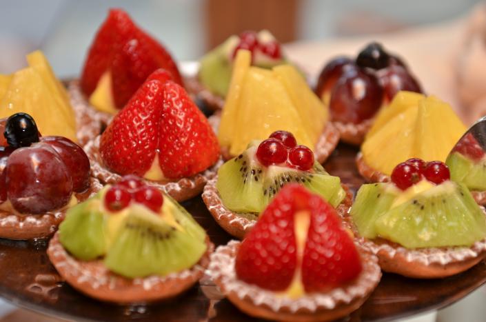 A platter that features a variety of our mini desserts all topped with fresh fruit.